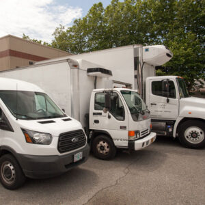 Art Shipping Services - Three moving vans and trucks parked - Art Work Fine Art Services