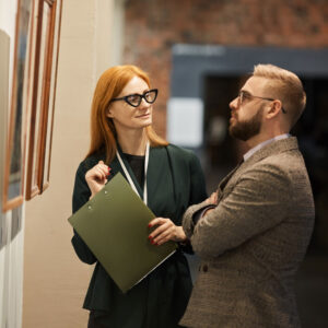 Support Services - A man and woman looking at a piece of art on the wall