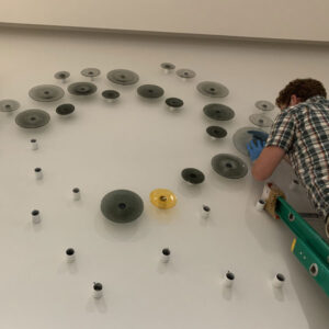 Art Installation Services - Man installing art piece